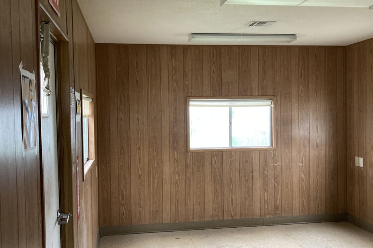 Mobile office entryway and window with wood paneling